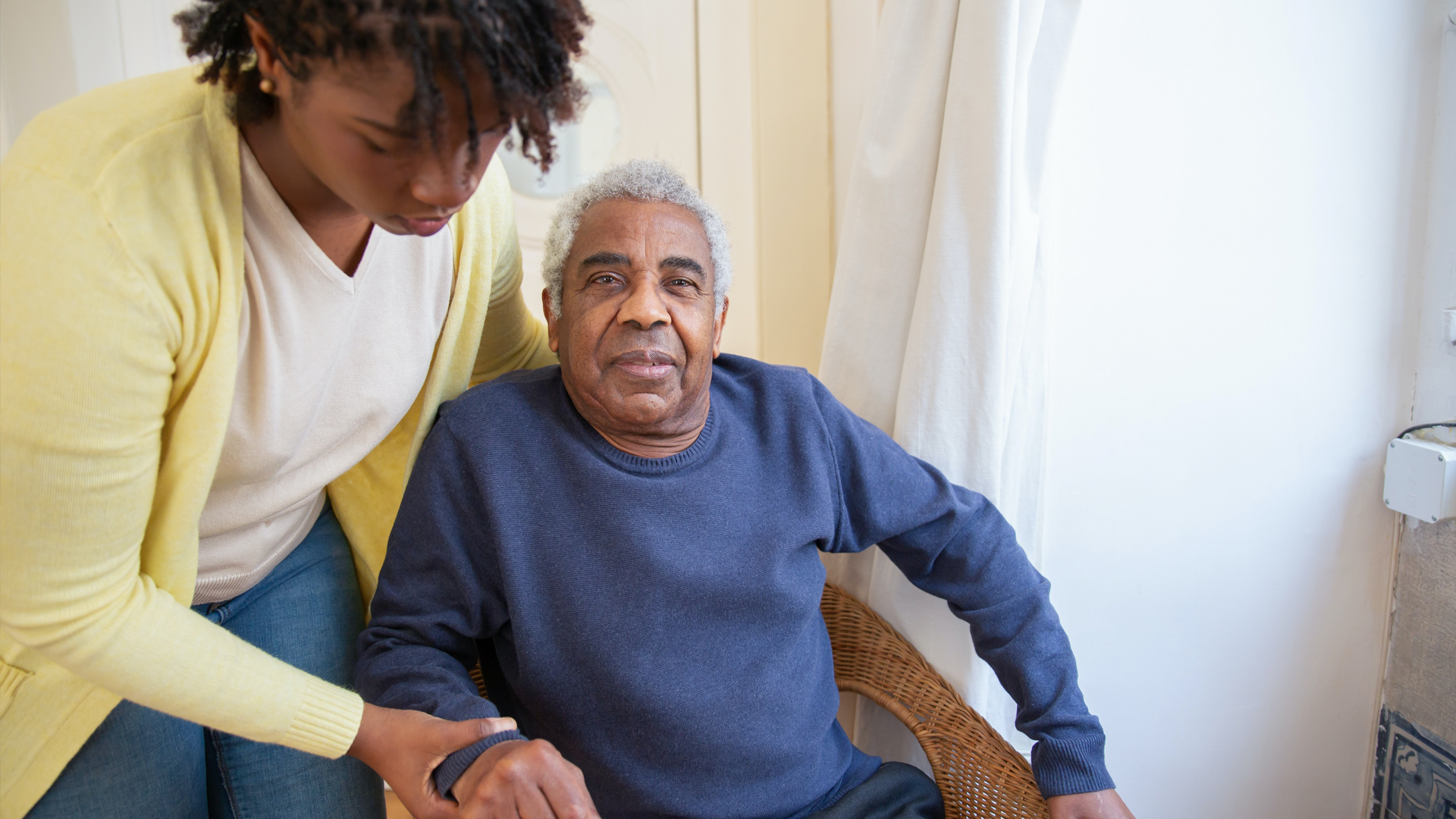 Photo showing carer helping elderly man