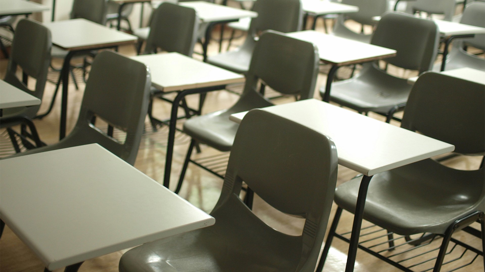 Photo showing empty school chairs in rows