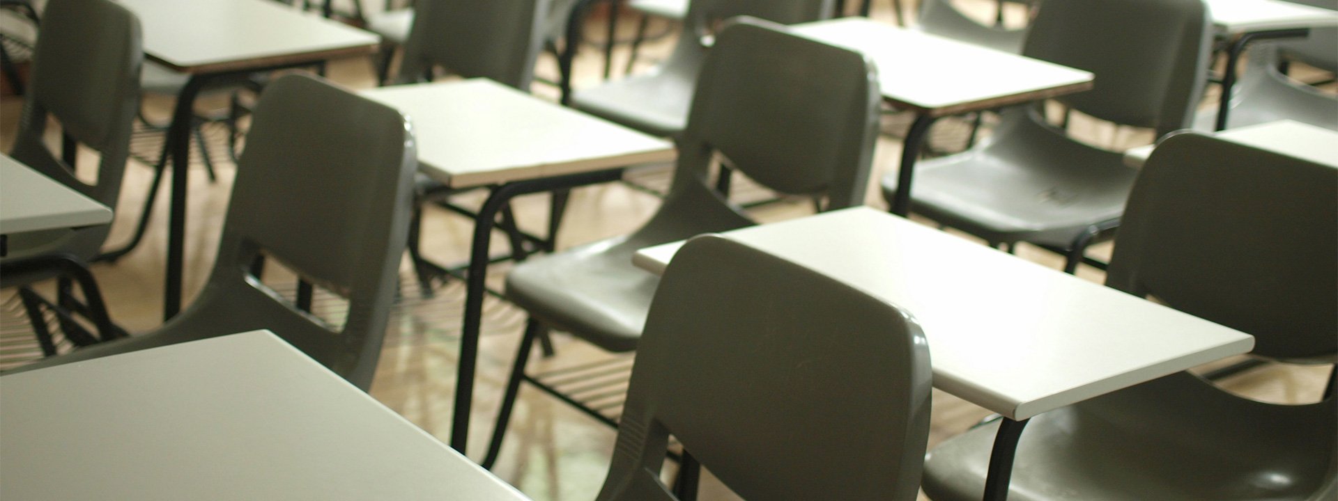 Photo showing empty school chairs in rows