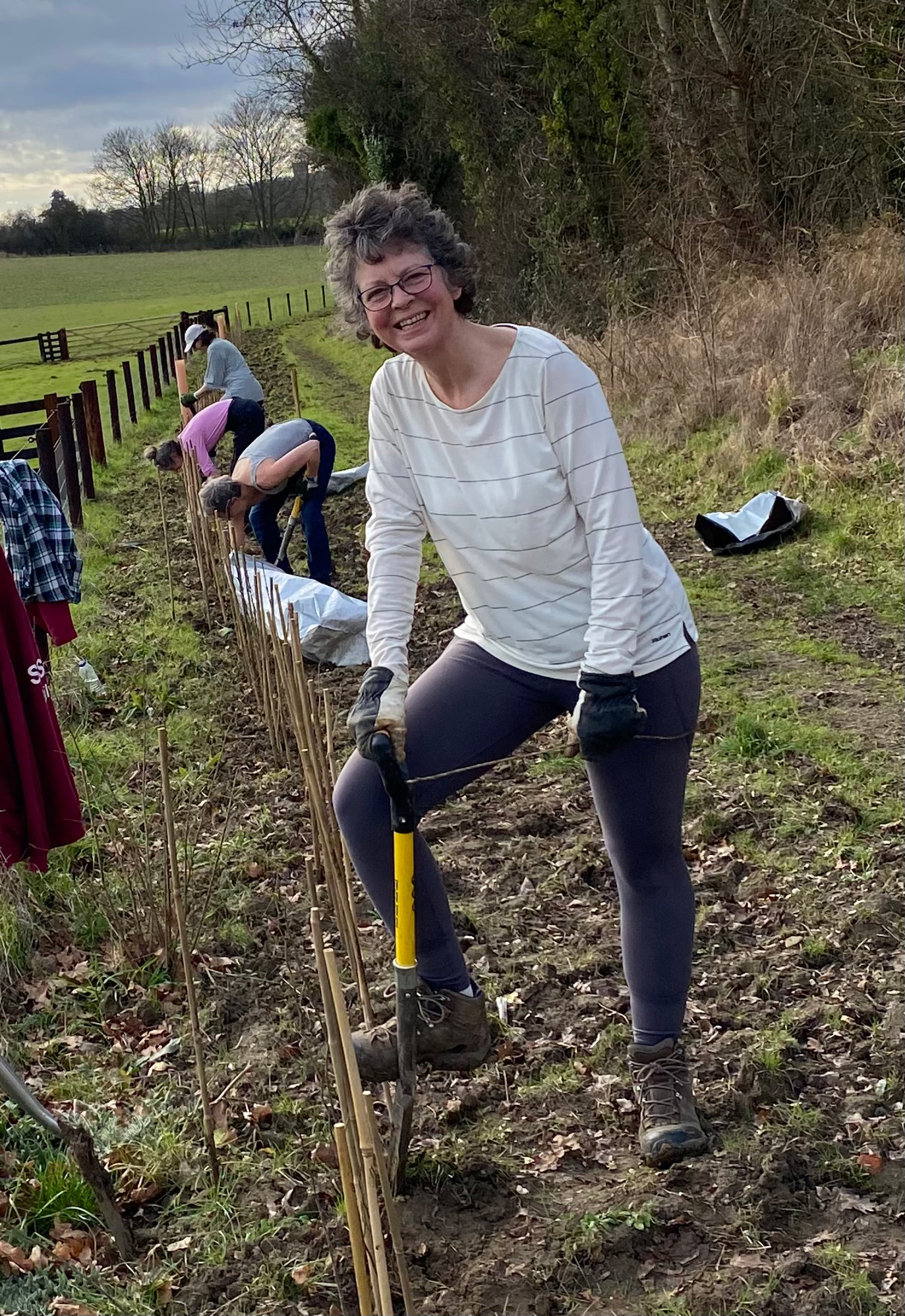 photo of Sarah Whitelock doing some gardening in a field